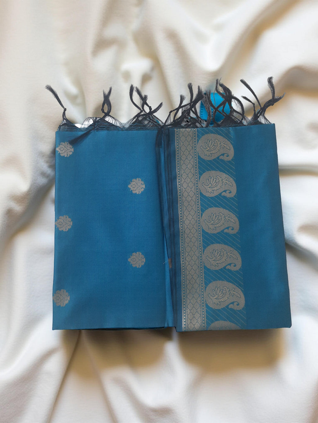 A Banarasi-inspired Blue Art Silk Dupatta with Tassels by Ladylike Accoutre, displayed on a clean white background. Features gold zari butti floral motifs and an intricate paisley border.