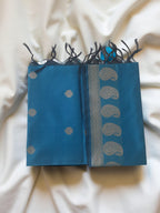 A Banarasi-inspired Blue Art Silk Dupatta with Tassels by Ladylike Accoutre, displayed on a clean white background. Features gold zari butti floral motifs and an intricate paisley border.