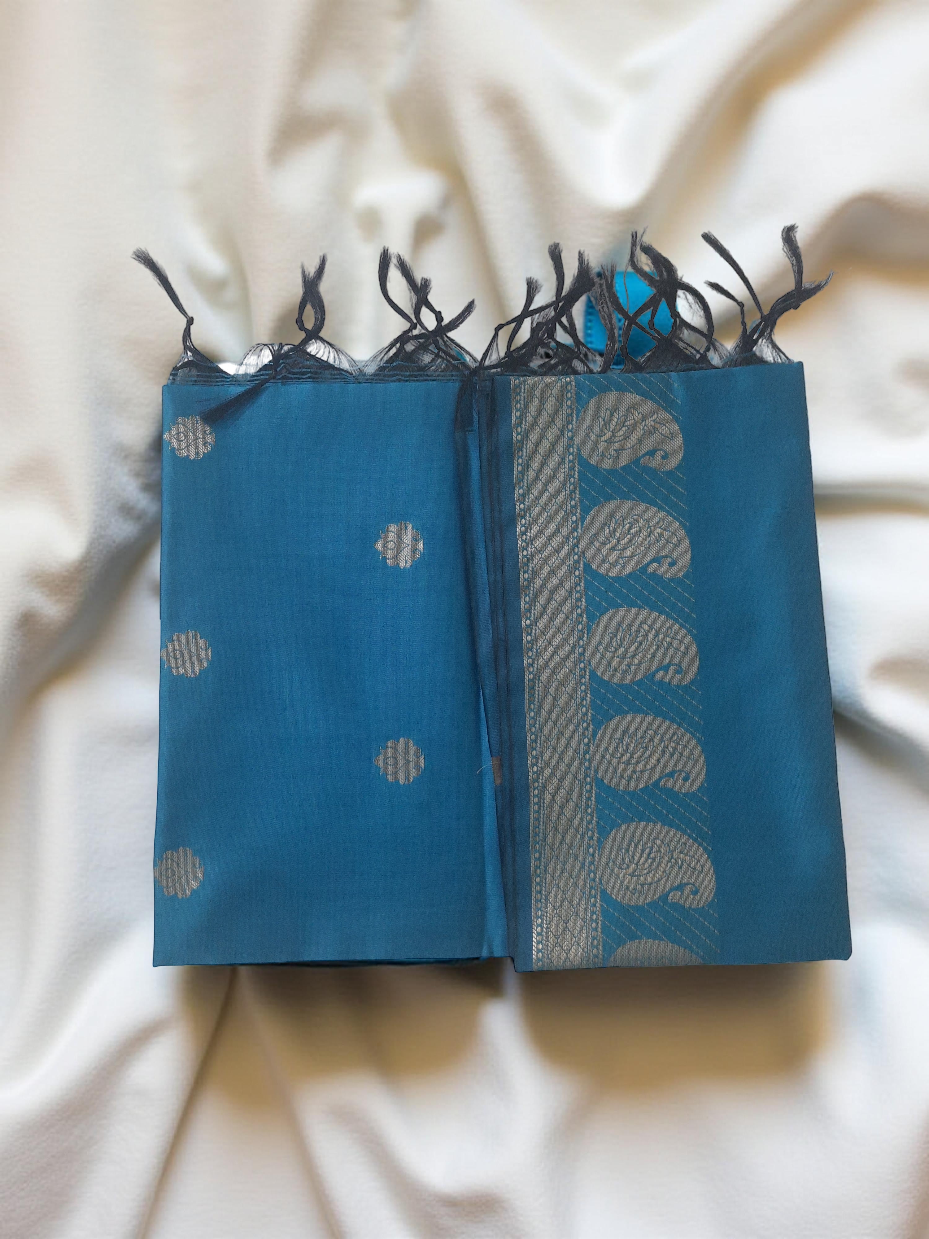 A Banarasi-inspired Blue Art Silk Dupatta with Tassels by Ladylike Accoutre, displayed on a clean white background. Features gold zari butti floral motifs and an intricate paisley border.