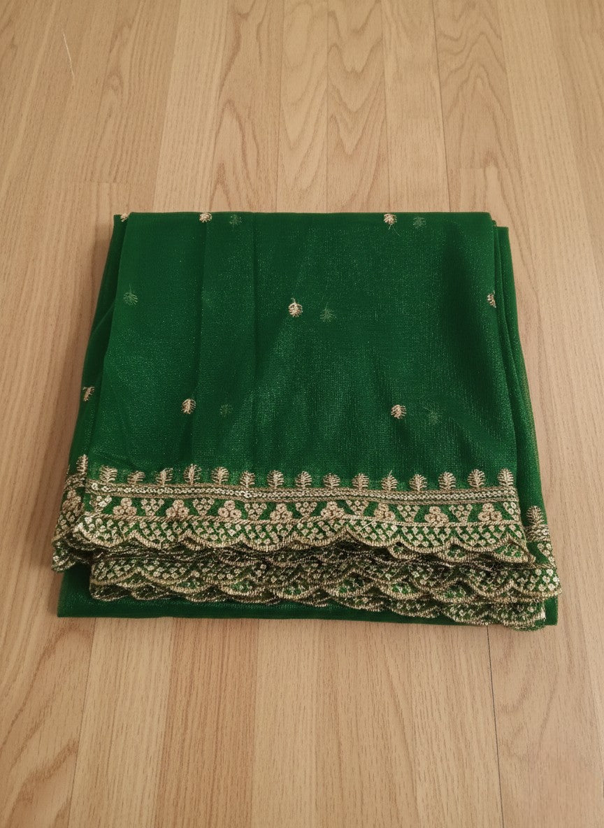 Bottle-green net dupatta with sequin embellishments and gold thread embroidered border on a wooden floor by Ladylike Accoutre.