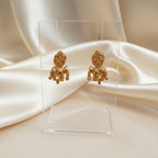 A Pair of Elephant Motif stud earrings set on a cream shining background by Ladylike Accoutre