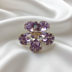 Gold-Tone Crystal Flower Hair Claw Clip in purple, adorned with sparkling heart-shaped crystals.