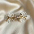 Gold-Tone hair barrette with white textured leaves and shimmering crystals on a light gold silk background by Ladylike Accoutre.