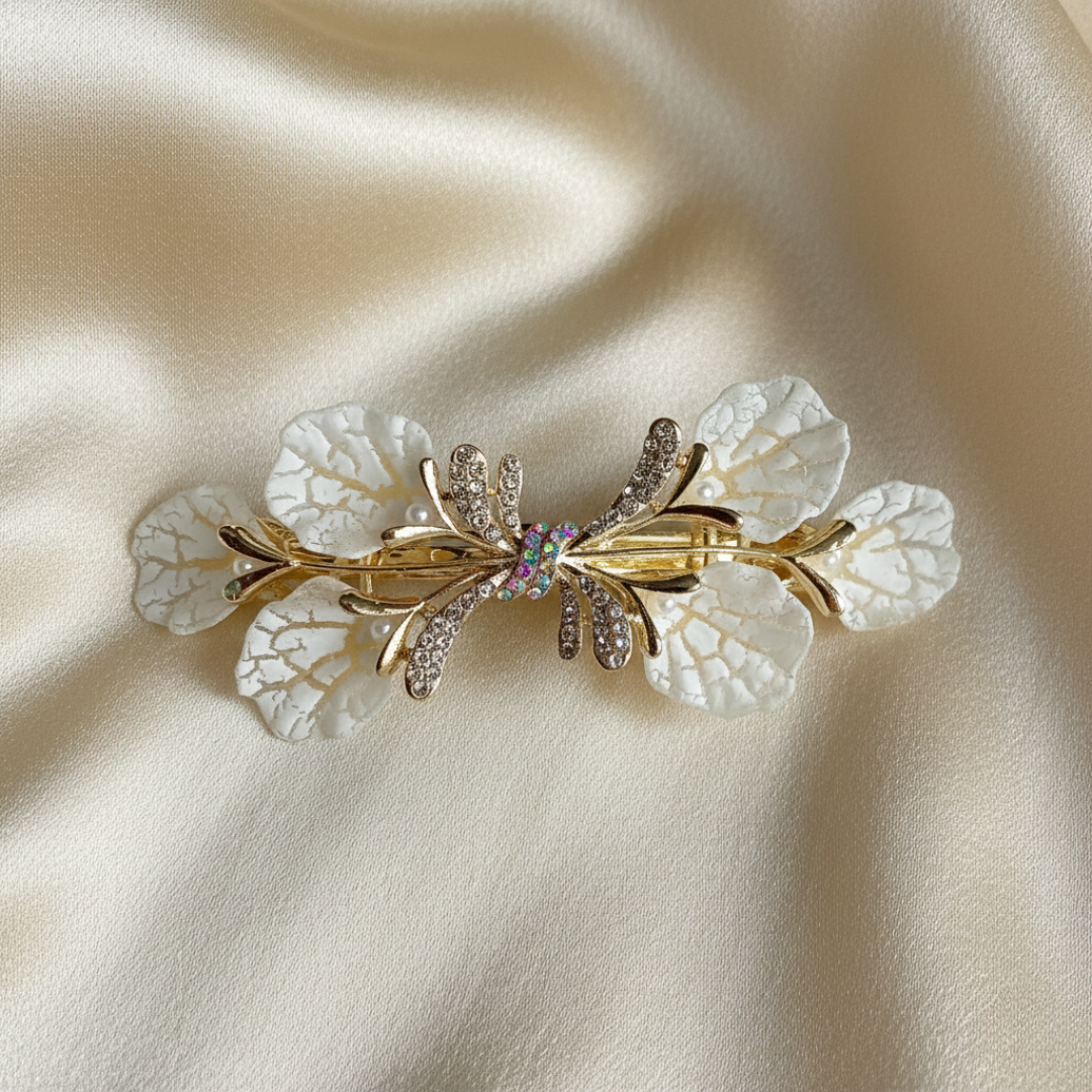 Gold-Tone hair barrette with white textured leaves and shimmering crystals on a light gold silk background by Ladylike Accoutre.