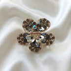 Gold-Tone Crystal Flower Hair Claw Clip in black, adorned with sparkling heart-shaped crystals.