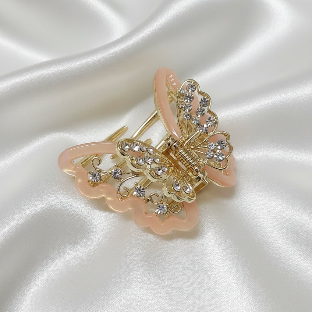 Gold-Tone Peach Butterfly Hair Claw Clip. Featuring translucent resin wings and sparkling crystals curated by Ladylike Accoutre.