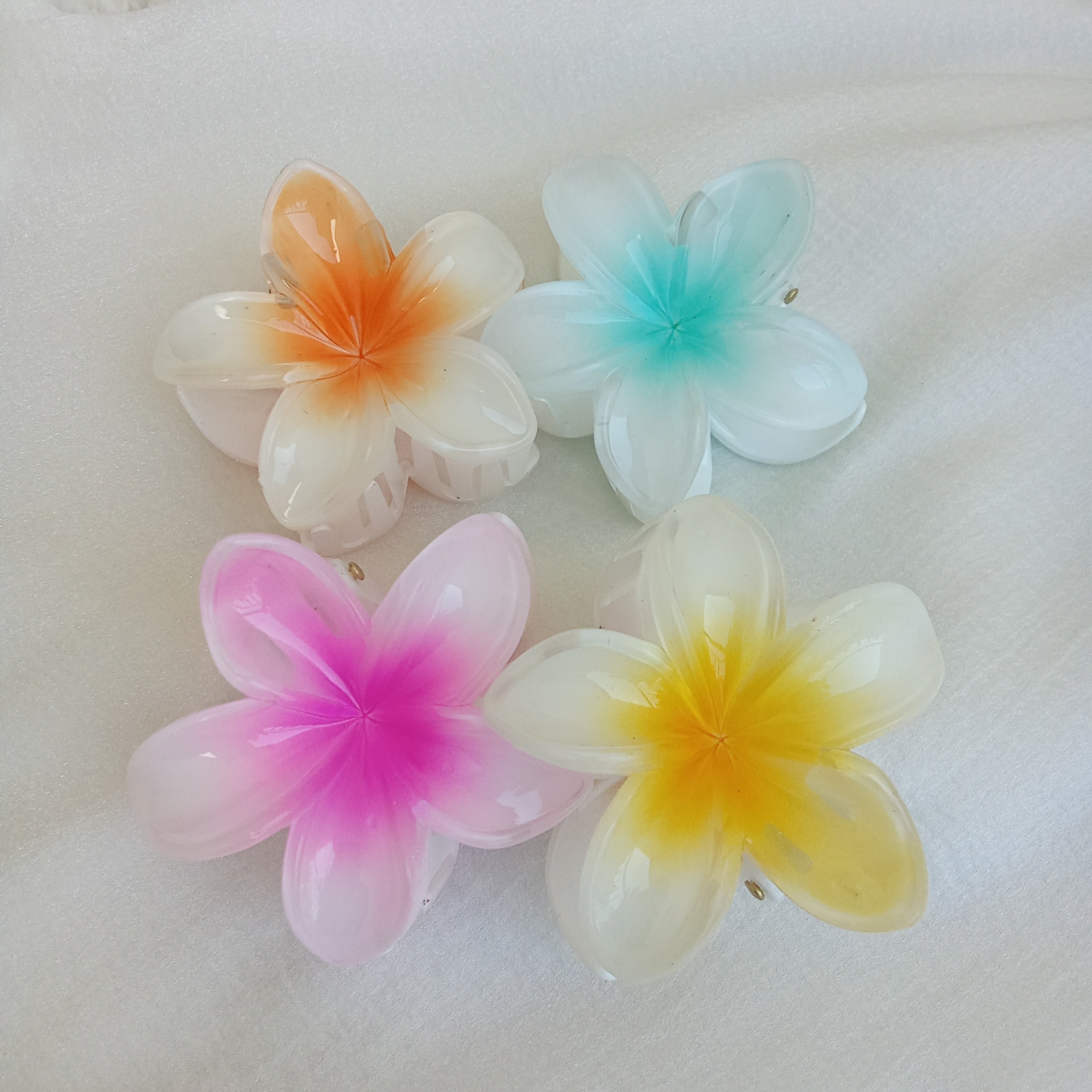 Plumeria Flower Hair Claw Clip, Set of 4 Clips. Featuring tropical gradient designs in Orange, Blue, Pink &amp; Yellow. Curated by Ladylike Accoutre.