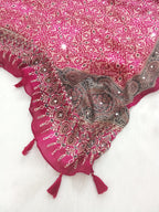 Magenta Pakistani print georgette dupatta with mirror work embellishments and tassels spread out on a white surface. Curated by Ladylike Accoutre.