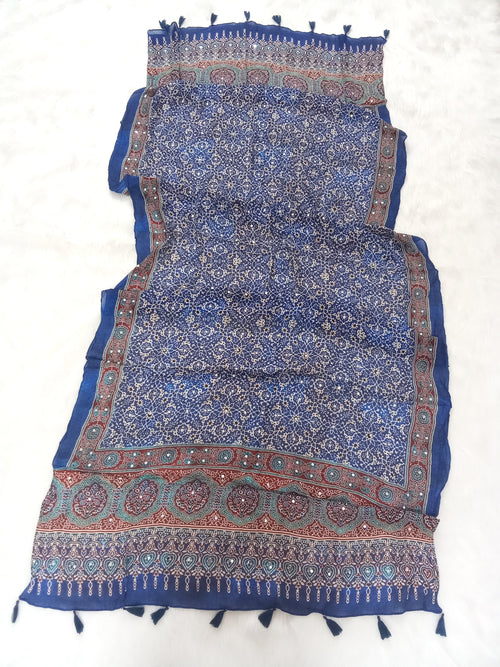 Blue Pakistani print georgette dupatta with mirror work embellishments and tassels spread out on a white surface. Curated by Ladylike Accoutre.