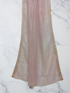 Muave net dupatta with sequin embellishments and gold thread embroidered border set against white marble background by Ladylike Accoutre. 