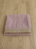 Muave net dupatta with sequin embellishments and gold thread embroidered border on a wooden floor by Ladylike Accoutre.