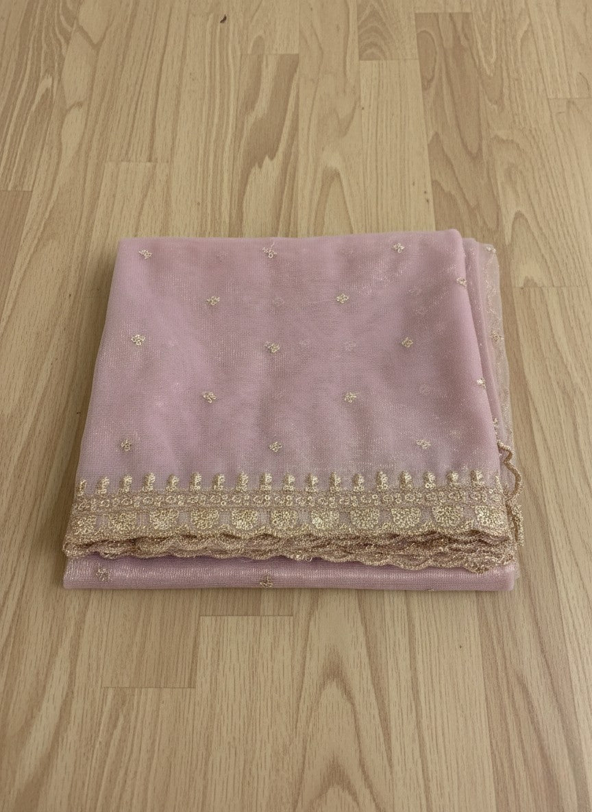 Muave net dupatta with sequin embellishments and gold thread embroidered border on a wooden floor by Ladylike Accoutre.
