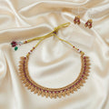 Gold-Tone Traditional Leaf Motif Necklace Set with Ruby-Red Accents and adjustable dori set on a cream shining background by Ladylike Accoutre