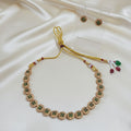 Gold-Tone Floral Temple Choker Necklace Set with Emerald-Green Stones & Matching Stud Earrings and adjustable dori set on a cream shining background by Ladylike Accoutre