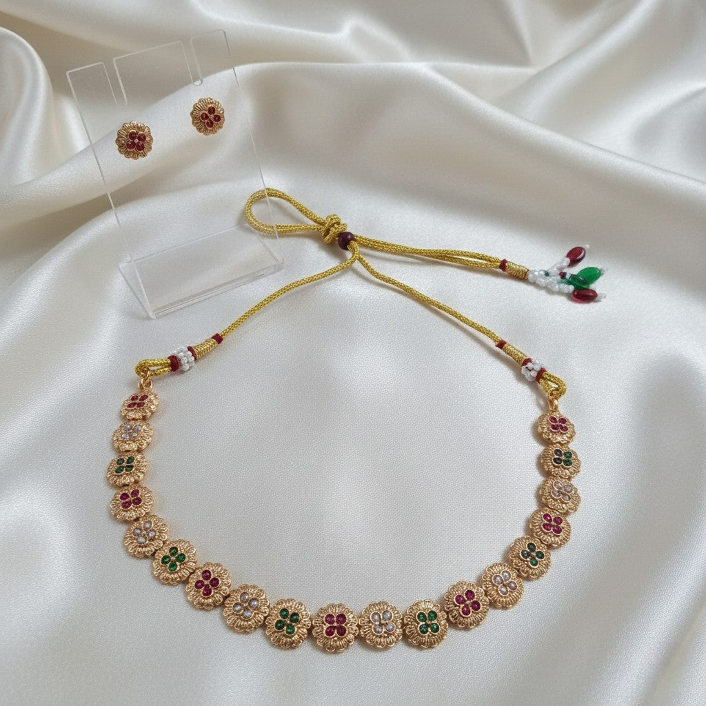Gold-Tone Floral Temple Choker Necklace Set with Multi-color Stones & Matching Stud Earrings and adjustable dori set on a cream shining background by Ladylike Accoutre