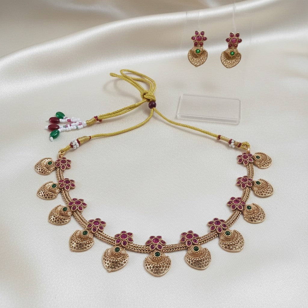 Gold-Tone Red & Green Kemp-Style Choker Jewellery Set with Matching Earrings and adjustable dori set on a cream shining background by Ladylike Accoutre