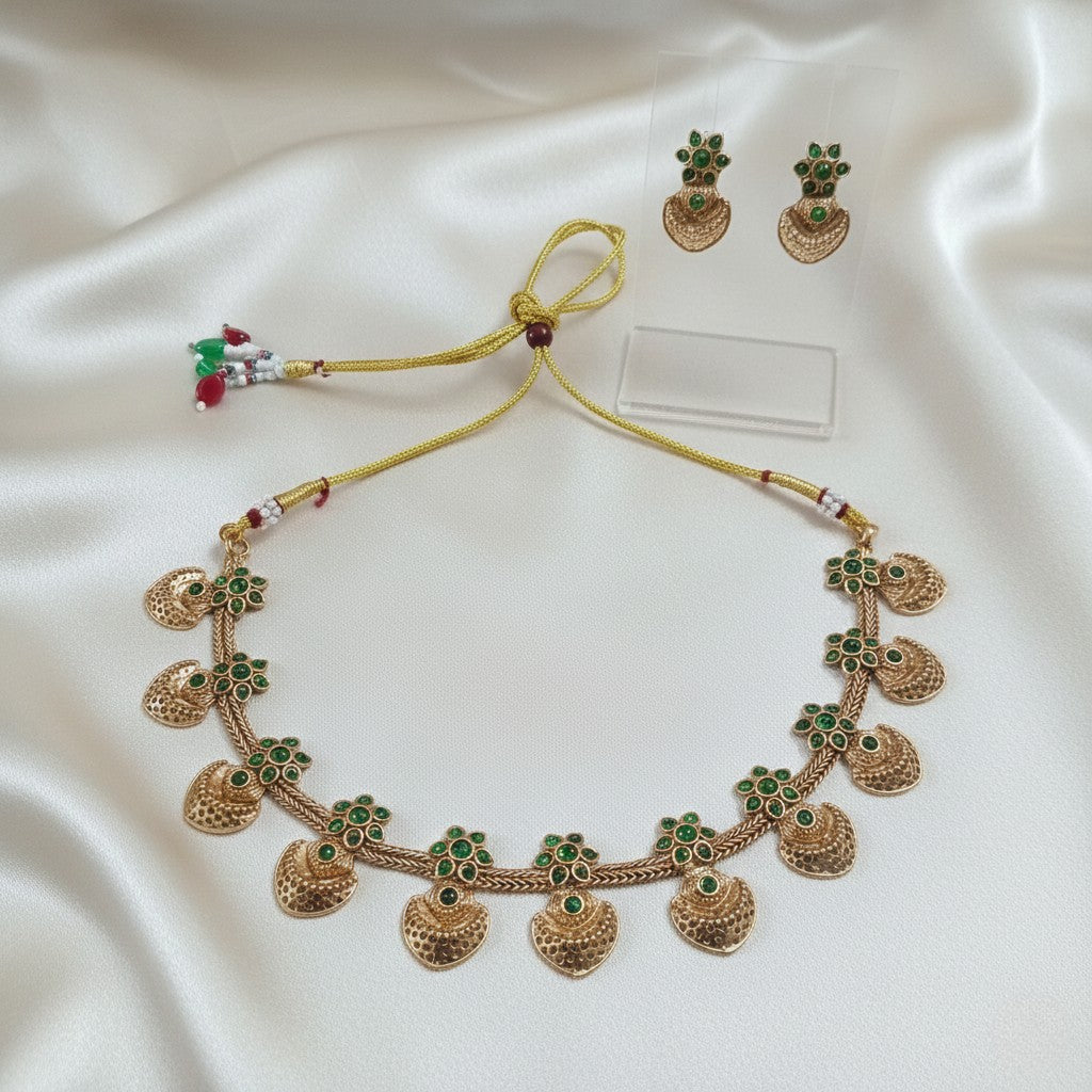 Gold-Tone Emerald-Green Kemp-Style Choker Jewellery Set with Matching Earrings and adjustable dori set on a cream shining background by Ladylike Accoutre