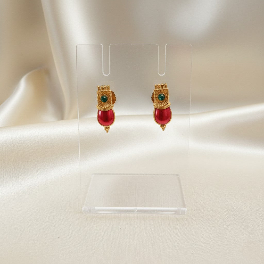 A Pair of Palakka Red stud earrings set on a cream shining background by Ladylike Accoutre